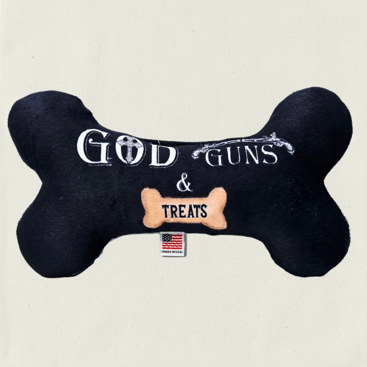 Black bone-shaped toy with text 'God Guns & Treats' .