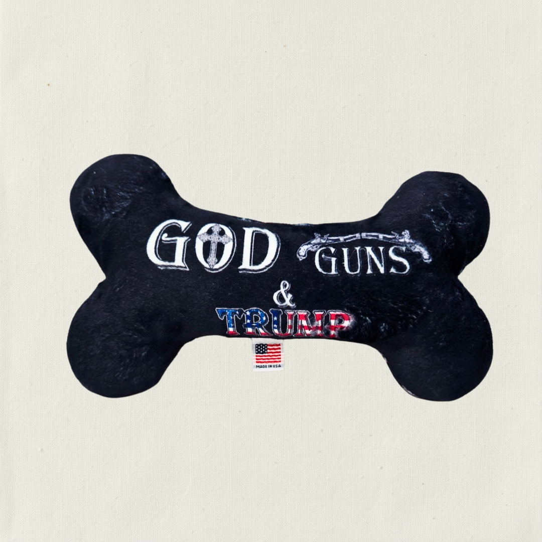 Black Bone shaped toy with text saying God, Guns & Trump